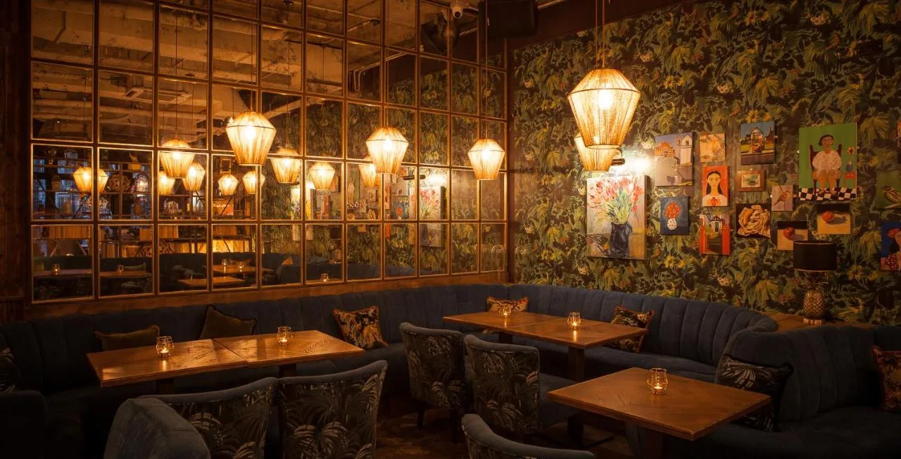 a restaurant with tables and chairs in a room at House Belfast Hotel in Belfast